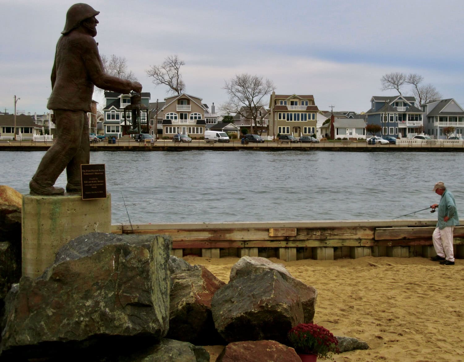 Fisherman's Memorial with fisherman at Point Pleasant jetty NJ