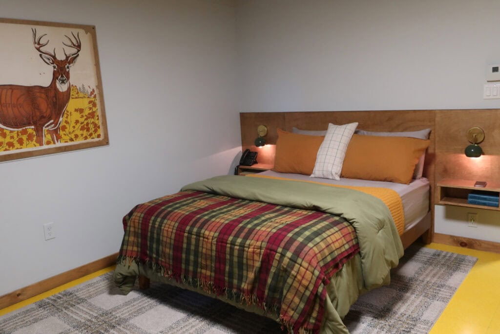 Andes Hotel room with mountain lodge bedding and deer art on walls